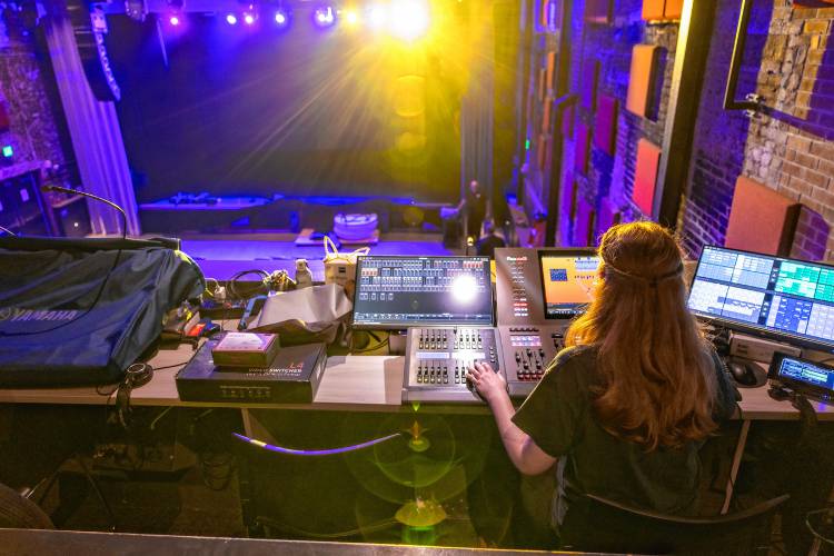 Erin works the lighting board at the New Hamphsire Stage on Janurary 31, 2025.