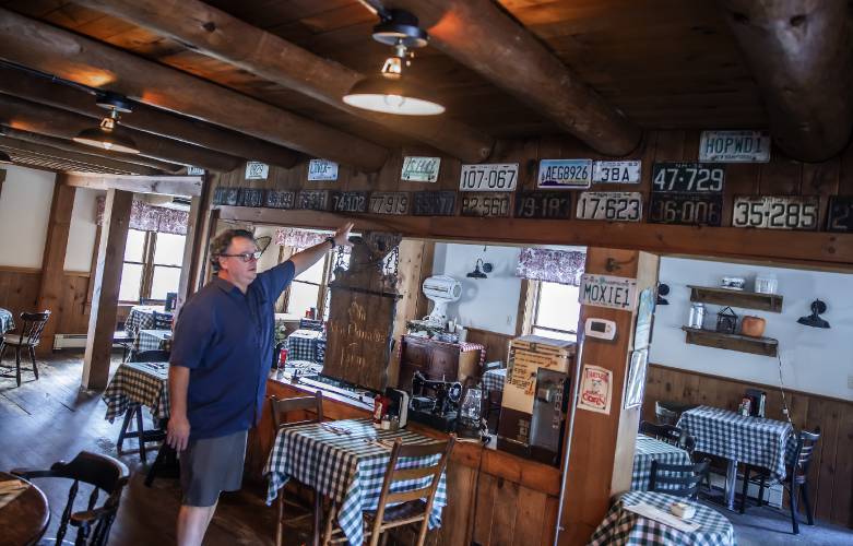 Peter ‘RePete’Fenton Jr. shows the old licenses in the main room of the Appleseed Restaurant in Bradford, which has been a staple in the community for the last 48 years.