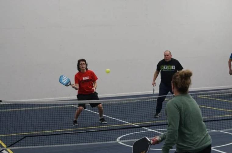 Nancy Morton returns a serve while playing pickleball at Gilford Hills Tennis & Fitness Club in Gilford.