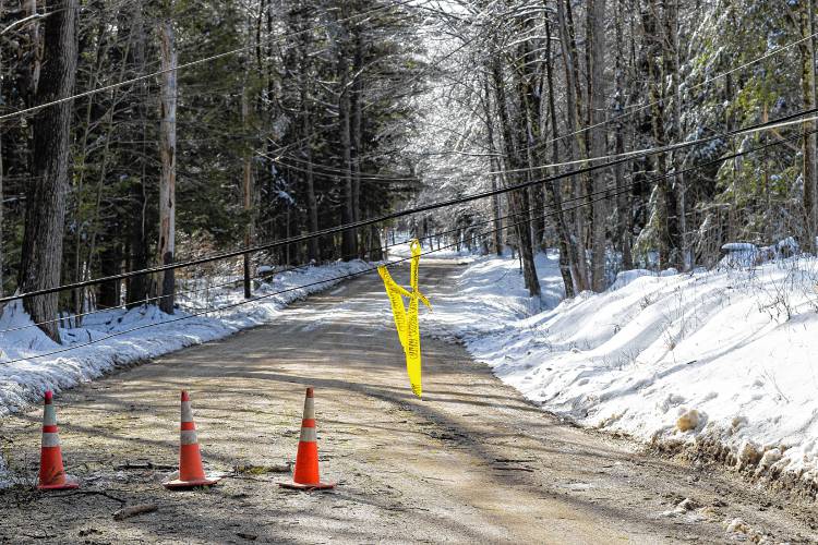 Lines across the road where a utlitity pole snapped off from its pole on Old Tilton Road in Canterbury on Monday, March 25, 2024.