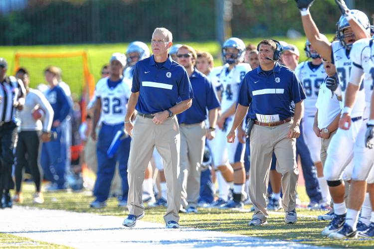 Kevin Kelly, left, on the sidelines as the head coach at Georgetown University. Kelly took over the  New England College program in August.