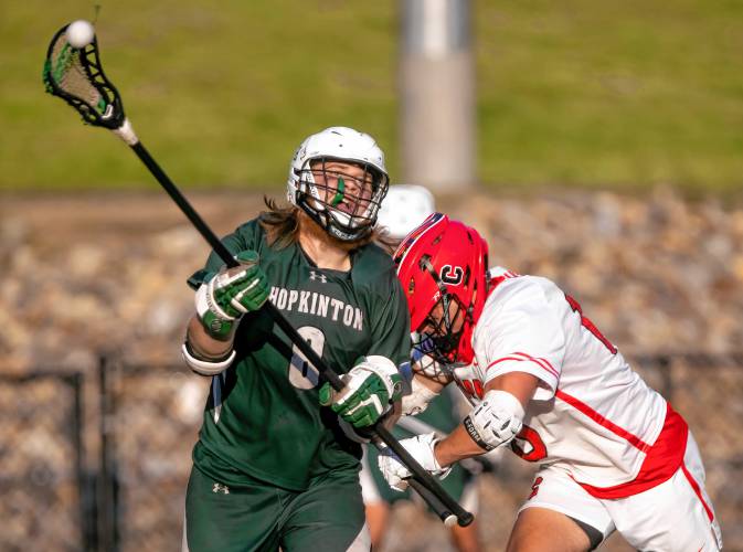 Hopkinton defenseman Kaleb Huse battles a Campbell defender during the D-III boys’ lacrosse semifinals in Laconia on Wednesday night. The Hawks were eliminated in a 13-4 defeat.