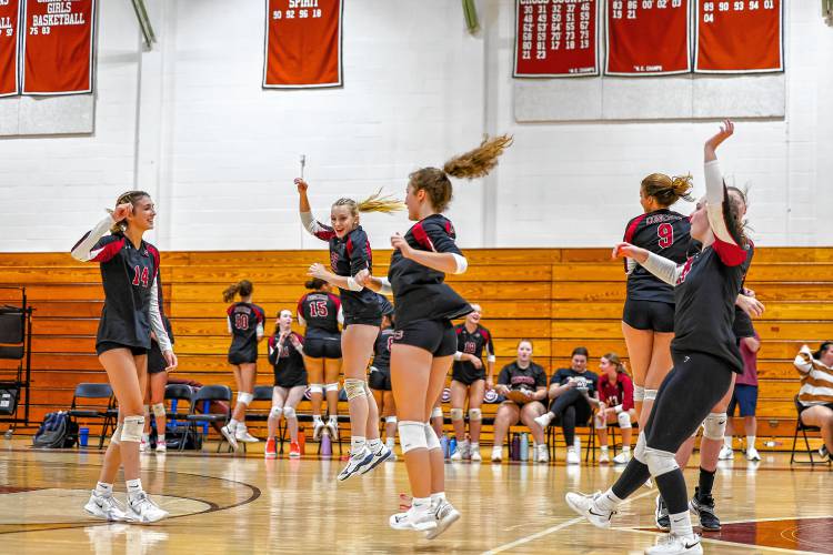 Concord High volleyball teammates ecstatically celebrate after an emphatic spike by senior Avery MacDonald (14) during Monday night’s four-set loss to Nashua North in Concord.