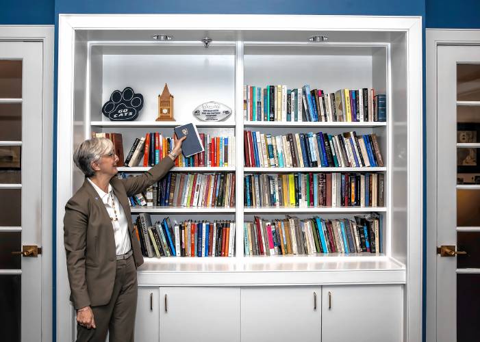 Elizabeth Chilton shows the trophy case in her office in Thompson Hall. She became the University of New Hampshire’s 21st president on July 1, 2024, three months after the protests on campus.
