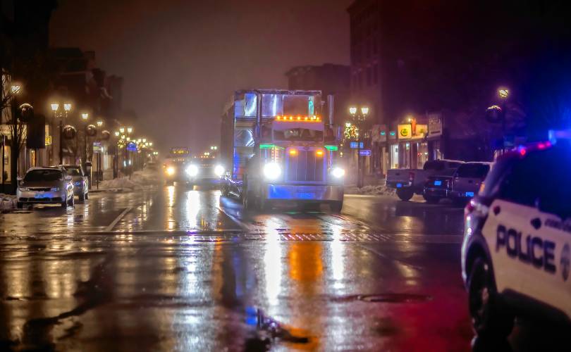 A Geddes Building Mover truck with a low load trailer makes its way on North Main Street with the kitchen portion of the diner on late Tuesday evening.