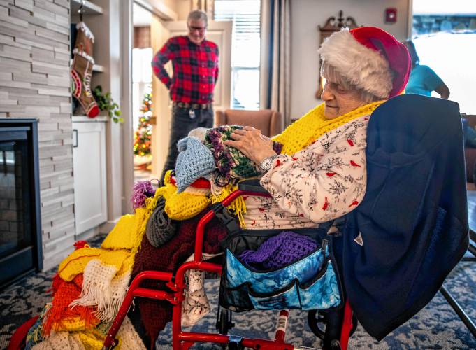 Lucienne Boisvert sits with all her creations brought to Peabody Place by her son, Michael.