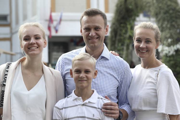 FILE - Russian opposition leader Alexei Navalny, with his wife Yulia, right, daughter Daria, and son Zakhar pose for the media after voting during a city council election in Moscow, Russia, on Sept. 8, 2019. Alexei Navalny, the fiercest foe of Russian President Vladimir Putin who crusaded against official corruption and staged massive anti-Kremlin protests, died in prison Friday Feb. 16, 2024 Russia’s prison agency said. He was 47. (AP Photo/Andrew Lubimov, File)