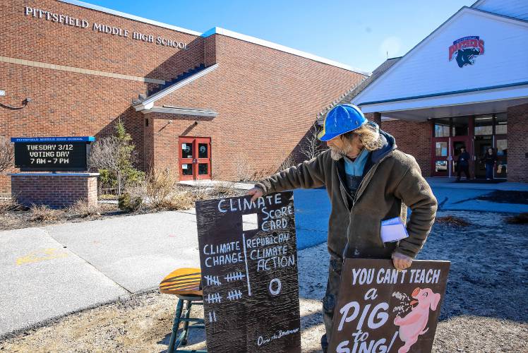 Dan “The Stoneman” Schroth takes up his signs as he gets ready to leave the Pittsfield Middle High School on Tuesday, March 12, 2024. Schroth is going to run for the State Legislature in the fall.