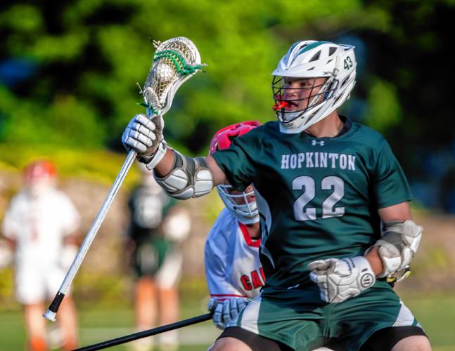 Hopkinton midfielder Jackson Westover battles against Campbell during Wednesday’s D-III boys’ lacrosse semifinal at Laconia High School.