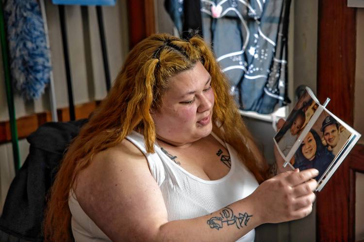 Brie looks at family photos of her with her father at her apartment in Rochester on March 4, 2025.