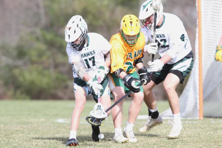 Hopkinton’s Merrick Chapin (left) battles with Bishop Brady freshman Ayman Anmed for control of a ground ball on Monday.