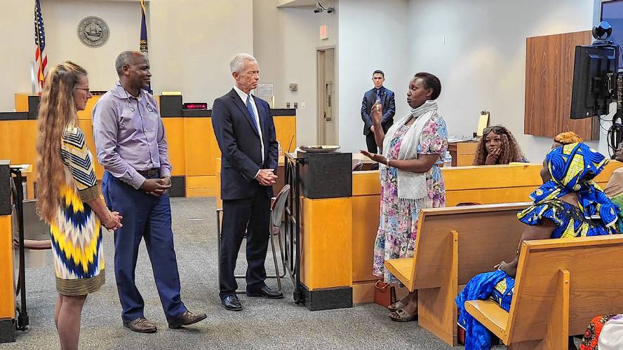 Circuit Court Judge Sue Carbon, Clement Kigugu and Chief Justice Gordon MacDonald meet with New American women to explain more about the state’s court system.