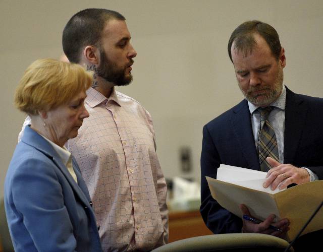 Adam Montgomery stands with his lawyers Caroline Smith and James Brooks as they await potential jurors to enter the courtroom for jury selection ahead of his murder trial at Hillsborough County Superior Court in Manchester, N.H, on Tuesday, Feb. 6, 2024. Montgomery is accused of killing his 5-year-old daughter and spending months moving her body before disposing of it. (David Lane/Union Leader via AP, Pool)