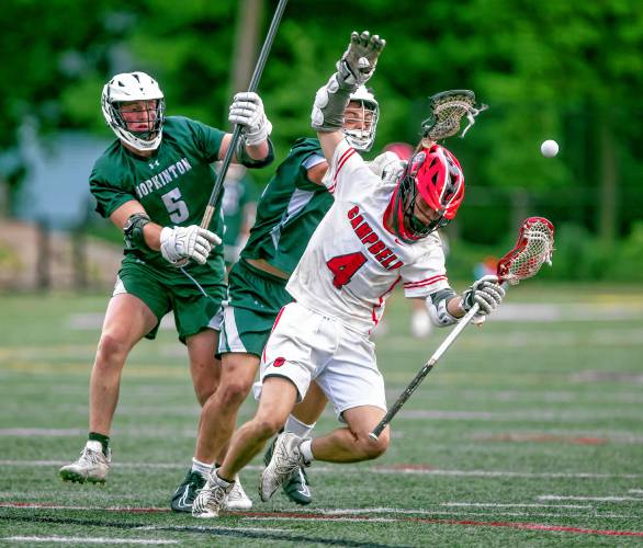 Hopkinton players Cameron Bassett (left) and Thaddeus Maughan battle Campbell midfileder Wyatt Tarr during the D-III boys’ lacrosse semifinal action.
