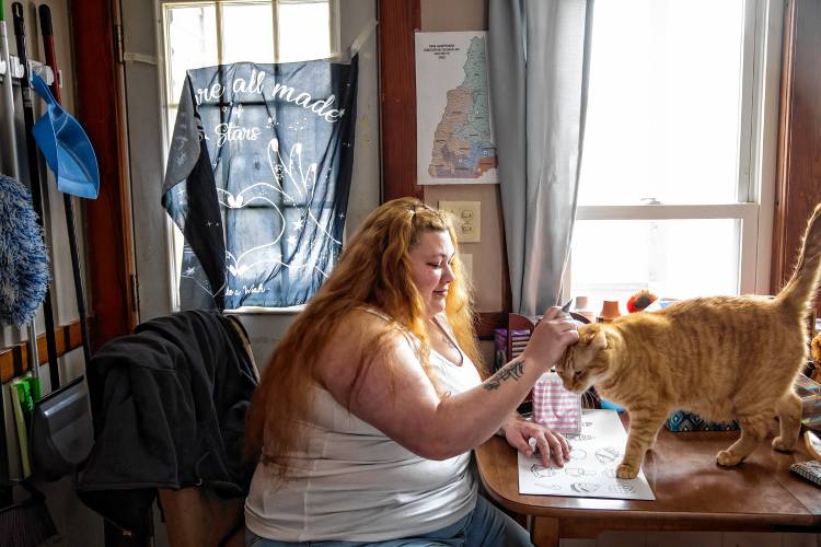 Brie Lamarche with her cat, Blaize, at her apartment in Rochester on March 4, 2025.