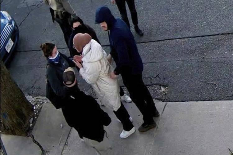 In this image taken from security camera video, Rumeysa Ozturk, a 30-year-old doctoral student at Tufts University, is detained by Department of Homeland Security agents on a street in Somerville, Mass., on March 26.