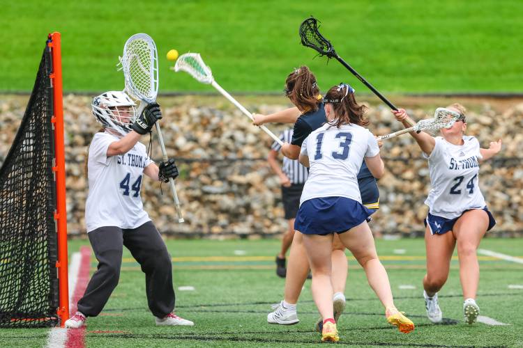 Senior attacker Ella Gray (blue) scored two of Bow’s goals against St. Thomas in her last game for the Falcons.
