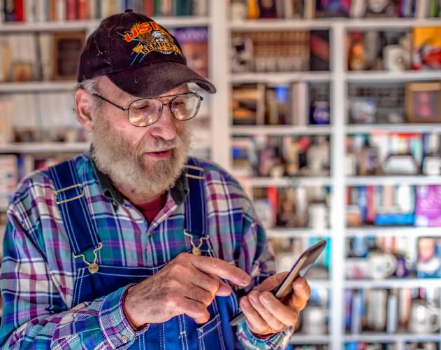 Denis O’Connell dials the Camp Lejeune number at his home in Concord earlier this month. O’Connell served in the Marines and was stationed at the giant military base where Marines and sailors train and operate.