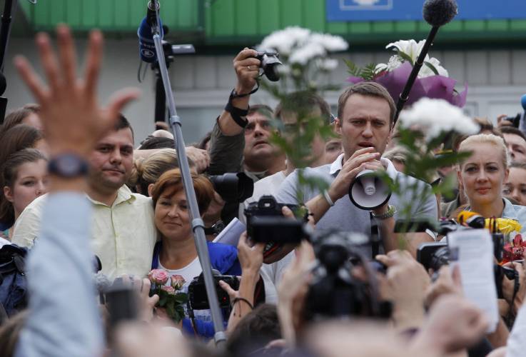 FILE - Russian opposition leader Alexei Navalny, 2nd right, addresses supporters and journalists after arriving from Kirov at a railway station in Moscow, Russia on July 20, 2013. Alexei Navalny, the fiercest foe of Russian President Vladimir Putin who crusaded against official corruption and staged massive anti-Kremlin protests, died in prison Friday Feb. 16, 2024 Russia’s prison agency said. He was 47. (AP Photo/Dmitry Lovetsky, File)