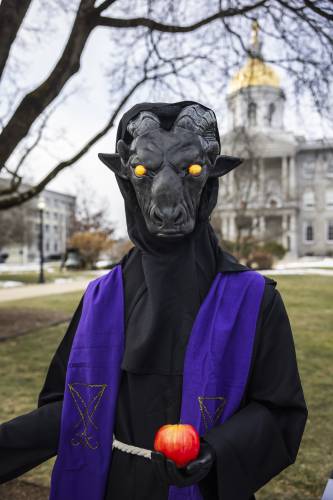 The Satanic Temple's holiday display has returned to its place outside the New Hampshire State House on Monday after it was vandalized a week ago.