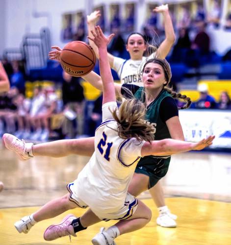 Kearsarge forward Kaelan Finnegan (21) draws an offensive foul on Hopkinton forward Zoe Bishop during the second half of their Tuesday night encounter.