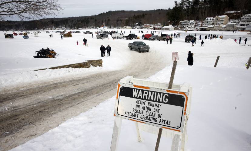 A warning sign greets visitors at the Alton Bay  airstrip on Sunday, February 2, 2025. The airstrip operates like any airport lacking a control tower. It is open from sunrise to sunset when conditions allow. The ice on Lake Winnipesaukee must be at least a foot thick over a large area; the runway is a minimum of 2,600 feet long and at least 100 feet wide.