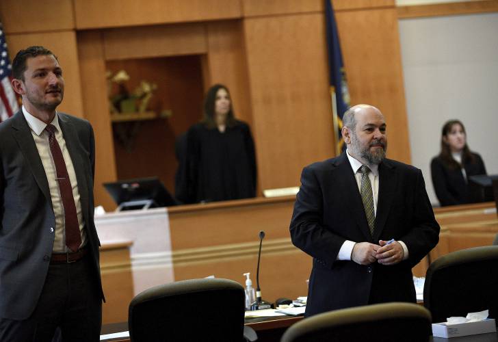 Assistant New Hampshire Attorney Generals Christopher Knowles, left, and Benjamin Agati stand as potential jurors enter the courtroom at jury selection for the Adam Montgomery murder trial at Hillsborough County Superior Court in Manchester, N.H, on Tuesday, Feb. 6, 2024. Montgomery is accused of killing his 5-year-old daughter and spending months moving her body before disposing of it. (David Lane/Union Leader via AP, Pool)