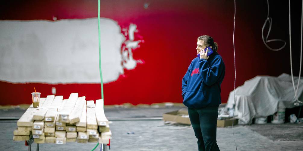 Kathy Miller talks with one the vendors that are helping convert the former fitness facility into the Capital City Billiards. 