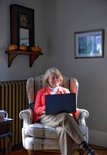 Jean Ver Hoeven, the Concord Town Crier, works in her South End home. The Town Criers are receiving a group service award at Monday’s Volunteer NH’s Spirit of NH Awards Ceremony.