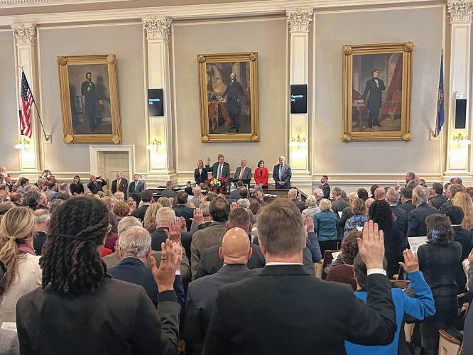 Members of the NH House of Representatives are sworn in by outgoing Gov. Chris Sununu. The Executive Council stands behind him.