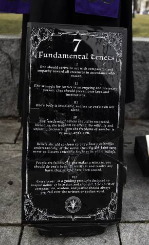 The Satanic Temple's holiday display has returned to its place outside the New Hampshire State House on Monday after it was vandalized a week ago.