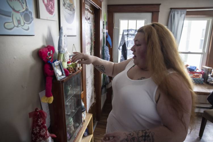 Brie Lamarche looks at the memory box in her kitchen of her apartment in Rochester.