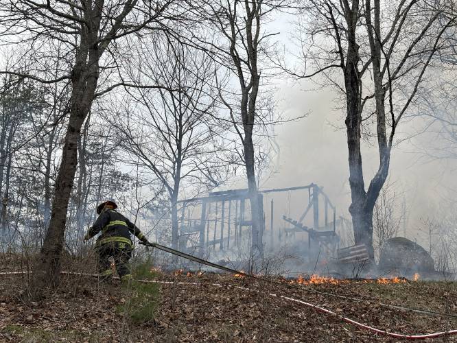 A fire at 100 Chase Farm Road in Hopkinton on Monday afternoon drew firefighters from around the area as flames spread from a garage to surrounding brush and fields.