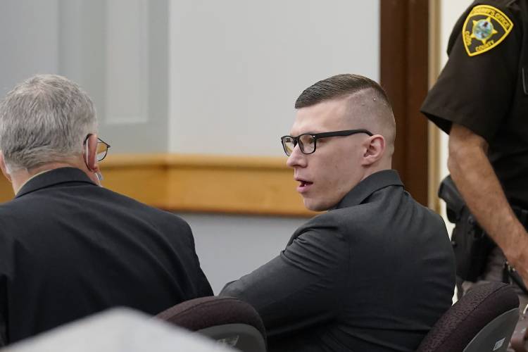 FILE - Volodymyr Zhukovskyy, of West Springfield, Mass., center right, charged with negligent homicide in the deaths of seven motorcycle club members in a 2019 crash, speaks with defense attorney Steve Mirkin, left, at Coos County Superior Court, in Lancaster, N.H., Monday, July 25, 2022. The prosecution has rested Zhukovskyy's case on Wednesday, Aug. 3. He faces negligent homicide and other charges in connection with the June 2019 crash in Randolph, New Hampshire (AP...