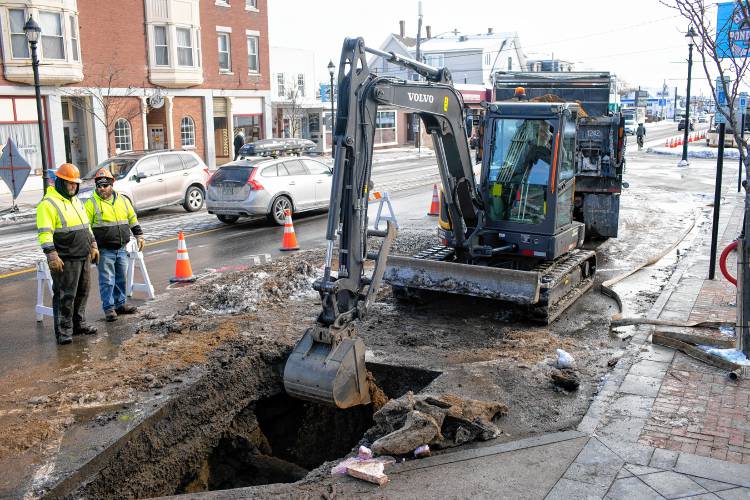Concord General Services work on filling the hole where a water main was leaking on South Main Street in Concord in front of the Capitol Center for the Arts on Thursday.