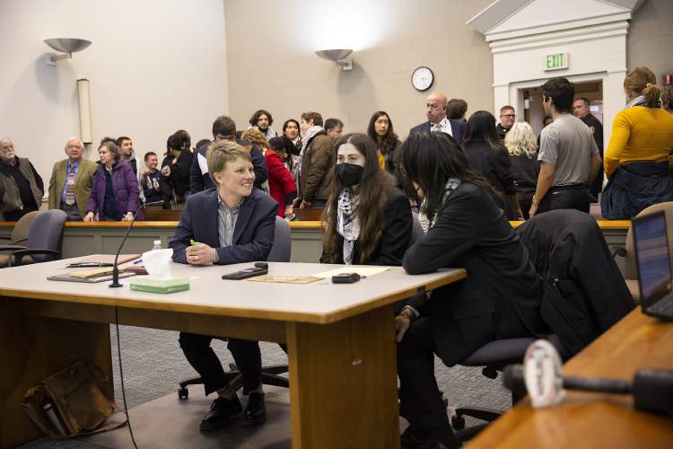 From left, defense attorney Kira Kelley talks to her clients, Dartmouth junior Roan Wade and freshman Kevin Engel, at the conclusion of the first day of their trial for misdemeanor criminal trespassing at Lebanon District Court in Lebanon on  Monday. The pair’s supporters filled the courtroom after participating in a demonstration in support of Palestine.
