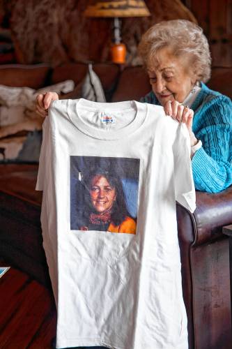 Maddie Dionne holds up a tee shirt of her daughter, Bobbie, at her son’s home in New Boston.
