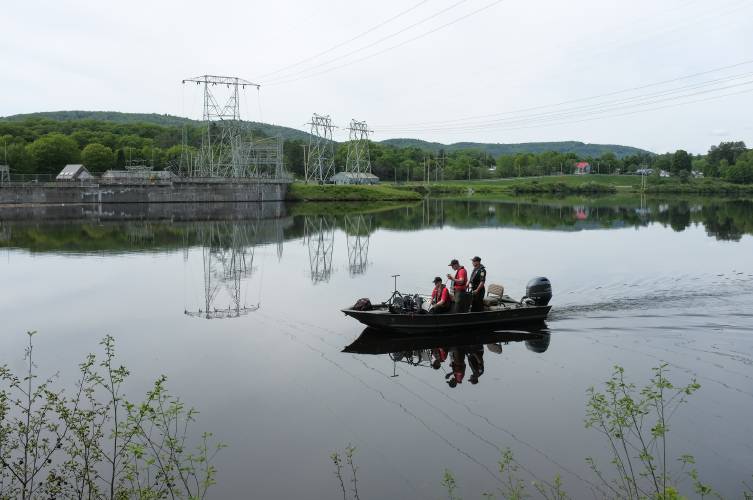 New Hampshire Fish and Game Conservation Officers, from left, Rob McDermott, Matt Holmes, and Lt. James Kneeland scan the bottom of the Connecticut River during a search for missing Dartmouth College graduate student Kexin Cai above the Wilder Dam in West Lebanon, N.H., on Monday, May 20, 2024. Cai, a graduate student in Dartmouth College’s Department of Psychological and Brain Sciences, was last seen on Wednesday, May 15, near her Drake Lane residence in West Lebanon and may have been riding a silver and white e-bike. (Valley News - James M. Patterson) Copyright Valley News. May not be reprinted or used online without permission. Send requests to permission@vnews.com.