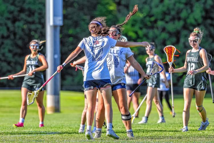 Freshman Lilly Jones (12) celebrates with junior Alyssa Brodeur after Brodeur scored her 100th career goal in Merrimack Valley’s first-round playoff victory over Manchester Central on May 28.