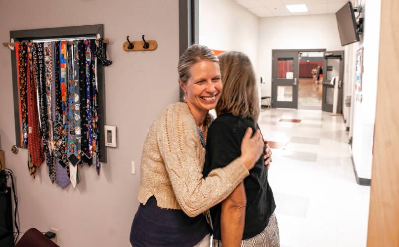 Loudon Elementary School reading teacher Stephanie Pike gets a hug from a co-worker during school on June 12.
