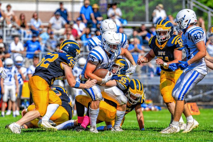 Pelham’s Junior MacKinnon (5) runs with the ball while the Bow defense attempts to take him down. MacKinnon ran for 127 yards on 16 carries, scored two touchdowns on the ground and caught a 17-yard TD pass to lead the Pythons to a 34-13 season-opening victory over the Falcons in Bow on Saturday.