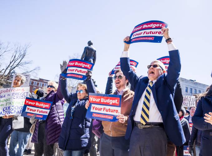 State Representative David Preece (right) joins a group of rally participants at the State House to protest the Republican proposed budget on Wednesday, April 9, 2025.