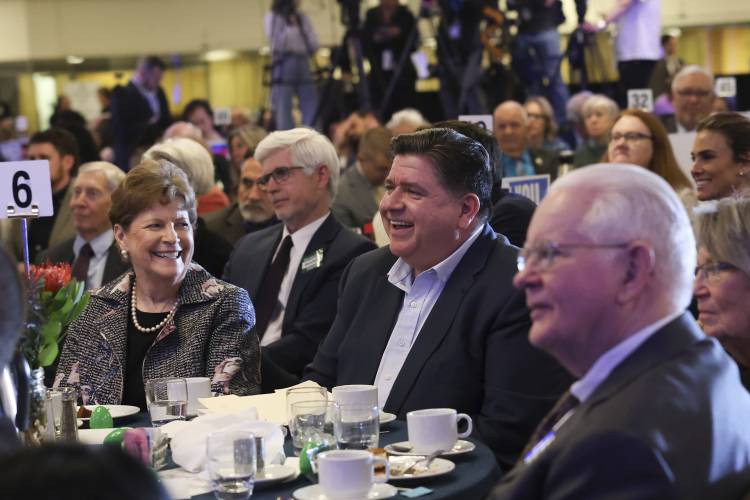 Illinois Gov. JB Pritzker, center, and Sen. Jeanne Shaheen, D-N.H., left, attend the McIntyre-Shaheen 100 Club Dinner, Sunday April 27, 2025, in Manchester, N.H. (AP Photo/Reba Saldanha)