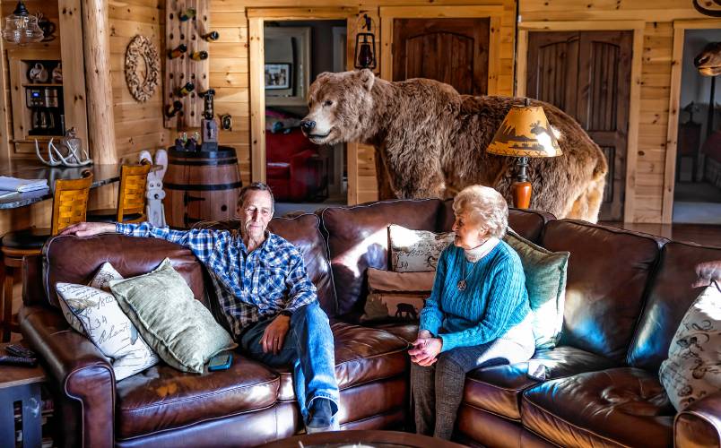 Ken Dionne sits in his living room with his mother Maddie in their New Boston home. He wonders if his sister’s killer will be caught.