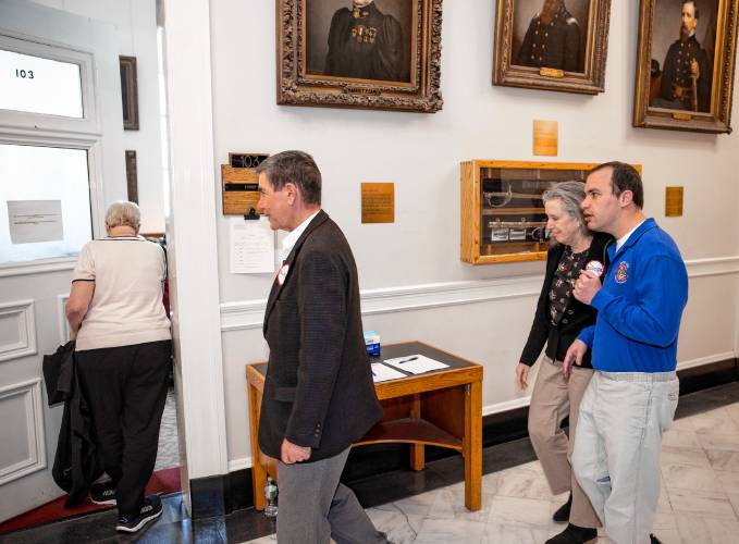 Phillip Kaneb walks into the hearing room with his parents, Stephen and Andrea, as they get ready to testify against HB 1283 in the afternoon session at the State House on Wednesday, April 24, 2024.