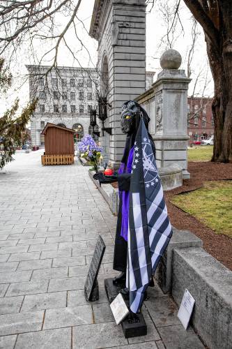 The Satanic Temple's holiday display has returned to its place outside the New Hampshire State House on Monday after it was vandalized a week ago.