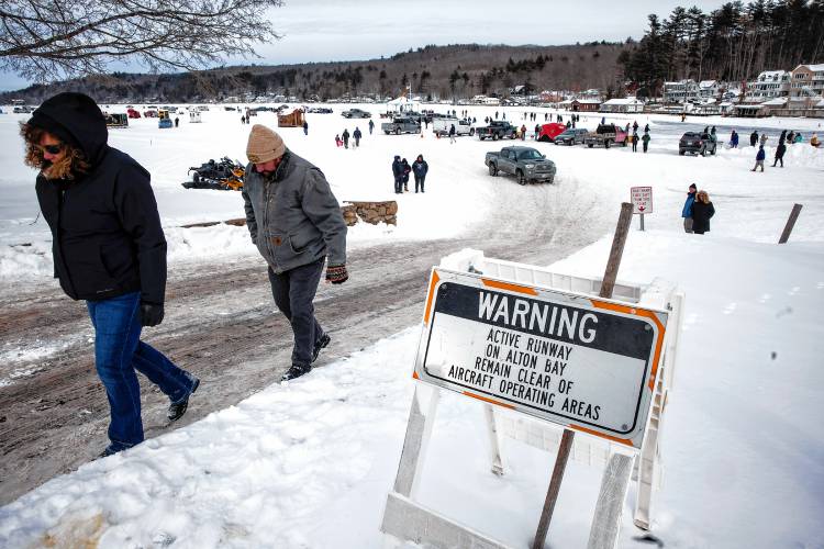 ABOVE: Visitors watch a plane take off at the Alton Bay airstrip on Sunday, February 2. The ice must be at least a foot thick on Lake Winnipesaukee at the bay for the landings. The runway is a minimum of 2,600 feet long and at least 100 feet wide.