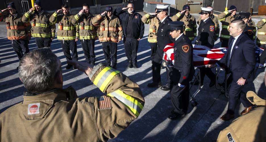 Firefighters from around the region salute as a color guard brings out Christopher Girard from the Medical Examimer’s office at Concord Hospital on Monday, March 3, 2025. Girard died last weekend after a brief illness. 