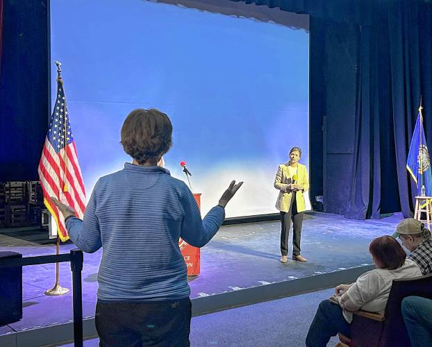 Maggie Goodlander speaks on stage at Concord High School’s auditorium.