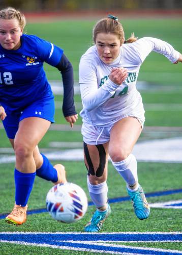 Hopkinton midfielder Keegan St. Cyr heads up the field as she battles Gilford defender Gracey LeBlanc during the Division III semifinal at Manchester Memorial on Nov. 1. St. Cyr was one of three Hopkinton players named to the Division III All-State First Team.